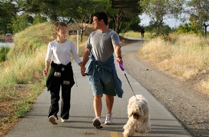 couple walking with dog